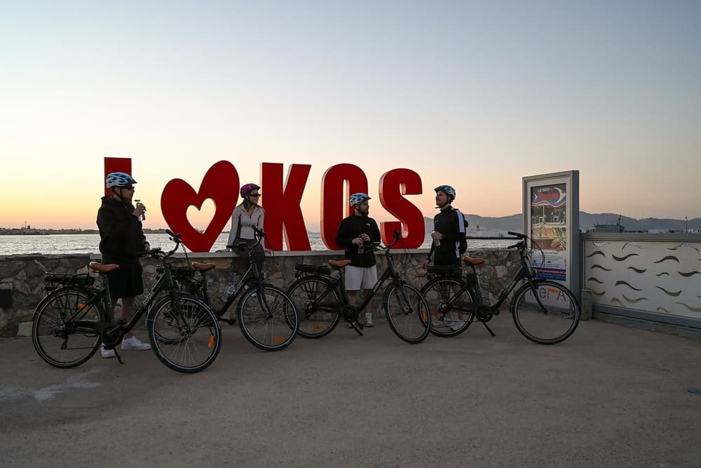 Group with e-bikes at the I Love Kos sign